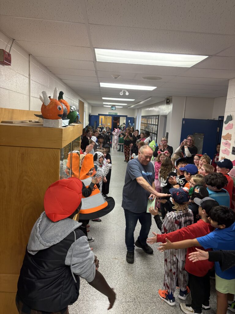 Mr. Walden walking the hall during clap out